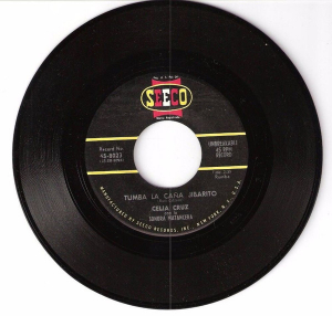 3.	Celia Cruz Con La Sonora Matancera – Tumba La Caña Jibarito / Nadie Me Lo Quita. Sello: Seeco – 45-8023. Formato: 45 RPM, País: Estados Unidos, Año 1960. Rumba y Merengue. 